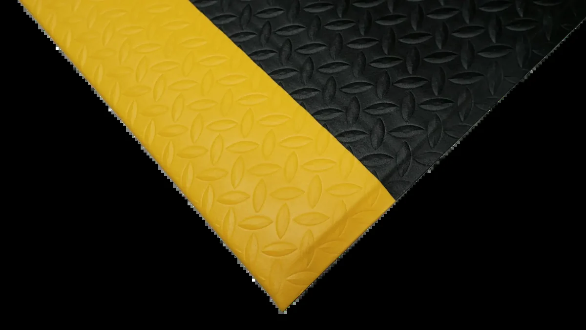 Corner of Diamond Plate matting showing the 12.7 mm thickness and the yellow bevelled edge