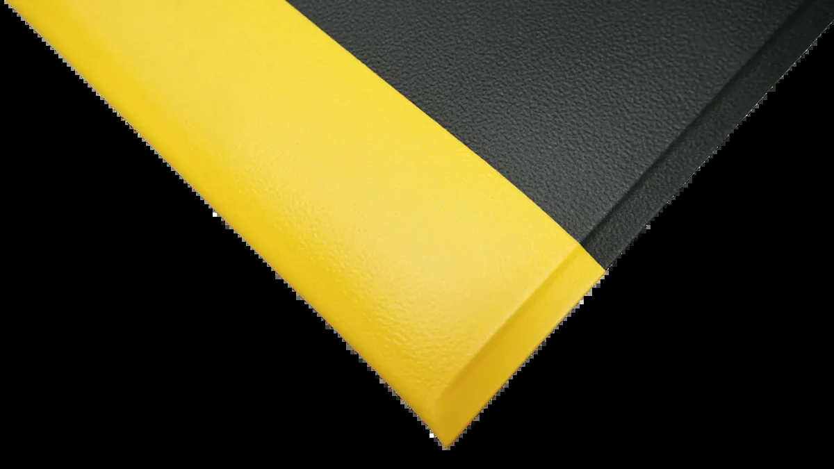 Corner of Elephant Skin matting showing the 9.5 mm thickness and the yellow bevelled edge